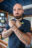 Mann mit Bart und gekreuzten Armen und geballten Fäusten in der Brücke der Humanity 1.