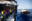 A Italian Coast Guard vessel next to the Humanity 1 with a lot of survivors on the main deck.