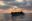 A boat in distress with a lot of people on it on the central Med