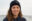 Frau mit Locken und SOS Humanity Mütze in blau.