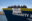 Crew an Bord des Rettungsschiffs Humanity 1 mit Plakat "Reffe the Justice Fleet"