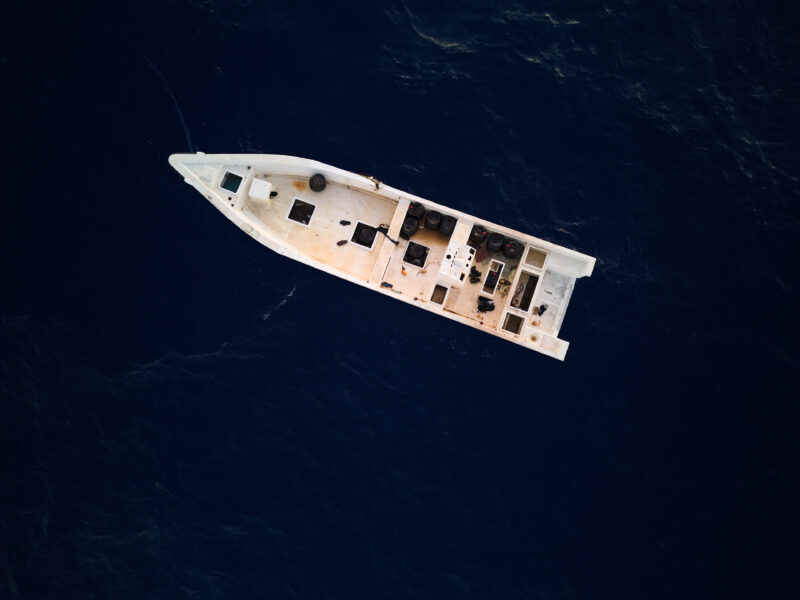 An empty white boat on the blue Mediterranean Sea that was probably intercepted.