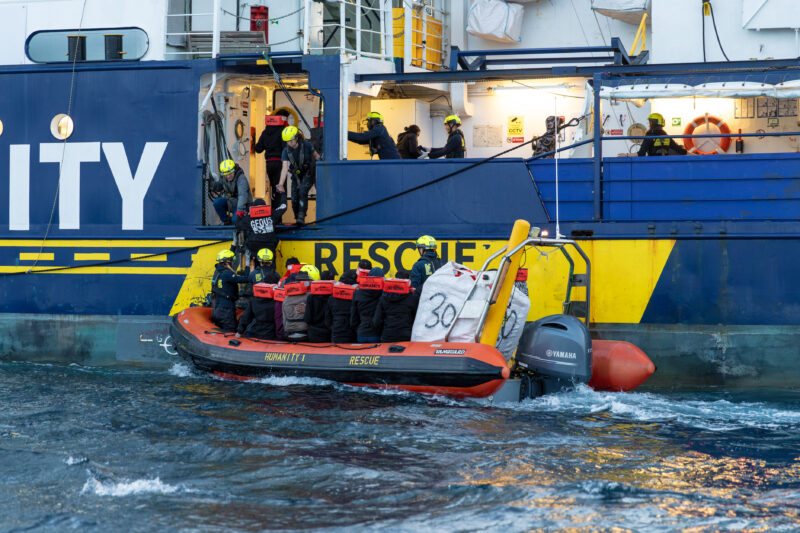 RHIB of SOS Humanity is approaching the Humanity 1 with crew members and suvivors onboard.